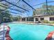 Enjoy this sparkling pool with screened enclosure, and lovely red brick edging that enhances this outdoor oasis at 8346 Mattituck Cir, Orlando, FL 32829
