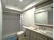 Bathroom featuring a shower-tub combo with white tile and a marble vanity at 9148 Oakwood Dr, Lake Wales, FL 33898