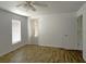 Spacious bedroom with hardwood floors, a ceiling fan, and a window bringing in natural light at 9148 Oakwood Dr, Lake Wales, FL 33898