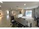 Open-concept living area with kitchen, dining space, and sliding doors to the backyard at 9148 Oakwood Dr, Lake Wales, FL 33898