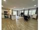 Open-concept living area with kitchen, dining space, and sliding doors to the backyard at 9148 Oakwood Dr, Lake Wales, FL 33898