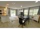 Open-concept living area with kitchen, dining space, and sliding doors to the backyard at 9148 Oakwood Dr, Lake Wales, FL 33898