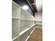 Walk-in pantry featuring custom built in shelves and sleek wood flooring at 9148 Oakwood Dr, Lake Wales, FL 33898