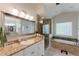 Bathroom featuring granite countertops, soaking tub, and glass shower with natural light at 9285 Wickham Way, Orlando, FL 32836