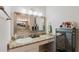 Bathroom with granite countertop, sink, large mirror, and cosmetic drawers for ample storage at 9285 Wickham Way, Orlando, FL 32836