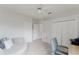 Well-lit bedroom offers closet space, seating, and light-colored vinyl floors at 9285 Wickham Way, Orlando, FL 32836