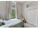 Bright bedroom with a large window that offers a serene outdoor view at 9285 Wickham Way, Orlando, FL 32836
