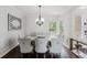 Elegant dining room with stylish chandelier, decor mirror, and comfortable seating for eight at 9285 Wickham Way, Orlando, FL 32836