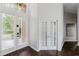 Inviting entryway featuring dark wood floors and glass-paneled doors for natural light at 9285 Wickham Way, Orlando, FL 32836
