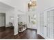 Bright entryway with high ceilings, elegant decor, and a view into the formal dining room at 9285 Wickham Way, Orlando, FL 32836