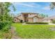 Charming two-story home featuring manicured landscaping, a grand entrance, and an inviting front yard at 9285 Wickham Way, Orlando, FL 32836