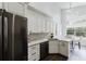 Bright kitchen with stainless steel appliances, granite countertops, and a view of the breakfast area at 9285 Wickham Way, Orlando, FL 32836