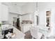 Eat-in kitchen with white cabinets and granite countertops next to dining area at 9285 Wickham Way, Orlando, FL 32836