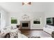 Living room featuring fireplace, high ceilings, and large windows at 9285 Wickham Way, Orlando, FL 32836