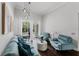 Comfortable living room with hardwood floors and stylish decor; enjoy the pool view from the expansive windows at 9285 Wickham Way, Orlando, FL 32836