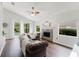 Bright living room with pool view, fireplace, and comfortable seating at 9285 Wickham Way, Orlando, FL 32836
