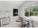 Bright home office with a desk, modern chair, and large windows with scenic views at 9285 Wickham Way, Orlando, FL 32836