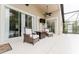 Comfortable outdoor patio featuring cushioned seating, a ceiling fan, and easy access to the pool at 9285 Wickham Way, Orlando, FL 32836