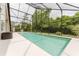 Inviting screened-in pool with an extended deck and a basketball hoop for Gathering fun at 9285 Wickham Way, Orlando, FL 32836