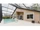 Relaxing screened-in pool with an extended deck, complemented by a comfortable seating area at 9285 Wickham Way, Orlando, FL 32836