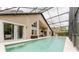 Inviting screened-in pool area with ample space for lounging and entertaining, surrounded by lush landscaping at 9285 Wickham Way, Orlando, FL 32836