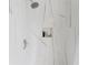 Modern tiled shower featuring sleek fixtures and a convenient in-wall niche for toiletries at 9285 Wickham Way, Orlando, FL 32836