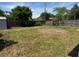 Expansive backyard featuring a mix of grass and bare patches surrounded by a wooden fence at 2315 Pembrook Dr, Orlando, FL 32810