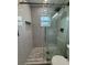 The bathroom has a tiled frameless shower and gray marble tiling and modern fixtures for a comfortable experience at 2315 Pembrook Dr, Orlando, FL 32810