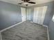 This bedroom features stylish gray marble floors, a ceiling fan, and a double door closet for extra storage at 2315 Pembrook Dr, Orlando, FL 32810