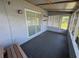 This enclosed patio area is great for relaxing with its tiled floors, neutral paint, and screened windows at 2315 Pembrook Dr, Orlando, FL 32810