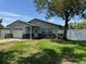 Well maintained single-story home features a lush green lawn and mature landscaping at 2315 Pembrook Dr, Orlando, FL 32810