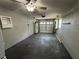 Open garage area featuring white walls, an electric garage door, and overhead lighting at 2315 Pembrook Dr, Orlando, FL 32810