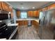 Well-lit kitchen with stainless steel appliances and wooden cabinets provides a modern look and ample storage space at 2315 Pembrook Dr, Orlando, FL 32810