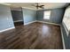 Open-concept living room with wood-look flooring, natural light, and a ceiling fan at 2315 Pembrook Dr, Orlando, FL 32810