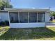 Back screened in porch with view of partially shaded backyard and concrete patio at 2315 Pembrook Dr, Orlando, FL 32810