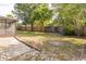Expansive backyard with lush trees, a screen enclosed porch, and a serene patio area perfect for outdoor entertaining at 1005 Black Willow Dr, Oviedo, FL 32765