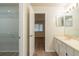 Bathroom view featuring an open doorway to a walk-in closet and a double sink vanity at 1005 Black Willow Dr, Oviedo, FL 32765