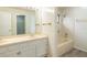 Bright bathroom with double sinks, wood-look flooring, and a bathtub with shower at 1005 Black Willow Dr, Oviedo, FL 32765