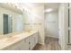 Bright bathroom with double sinks, wood-look flooring, and a shower stall at 1005 Black Willow Dr, Oviedo, FL 32765