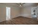 Open bedroom featuring a ceiling fan, wood-look flooring, and an open doorway at 1005 Black Willow Dr, Oviedo, FL 32765