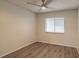 A spacious bedroom with a ceiling fan, wood-look flooring, and a bright window at 1005 Black Willow Dr, Oviedo, FL 32765