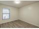 Cozy bedroom featuring wood-look floors and a bright window at 1005 Black Willow Dr, Oviedo, FL 32765