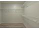Walk-in closet with wood-look flooring and open shelving for optimal storage at 1005 Black Willow Dr, Oviedo, FL 32765