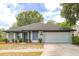 Charming single-story home features a well-maintained lawn, neutral paint, and a two-car garage at 1005 Black Willow Dr, Oviedo, FL 32765