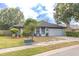 Landscaped front yard featuring a well-manicured lawn with mulch beds, bushes, and a two car garage at 1005 Black Willow Dr, Oviedo, FL 32765