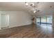 Large living room with wood-look floors, stylish ceiling fan and backyard access at 1005 Black Willow Dr, Oviedo, FL 32765