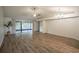 Bright living room featuring wood-look floors, modern ceiling fans, and sliding glass doors at 1005 Black Willow Dr, Oviedo, FL 32765
