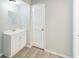 Bright bathroom with a modern vanity, ample storage and sleek wood-look flooring at 111 Tarrytown Trl, Longwood, FL 32750