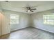 Bedroom with new vinyl plank floors, ceiling fan, natural light, and a large window at 111 Tarrytown Trl, Longwood, FL 32750