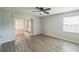 Bedroom with vinyl plank floors, ceiling fan, sliding glass doors, and natural light at 111 Tarrytown Trl, Longwood, FL 32750